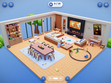 Organize It! living room: an isometric 3D living room with toys, books, cushions and a toy train set scattered around a dining table, sofas, a piano and a big TV over a fireplace, and a 0 of 25 counter.